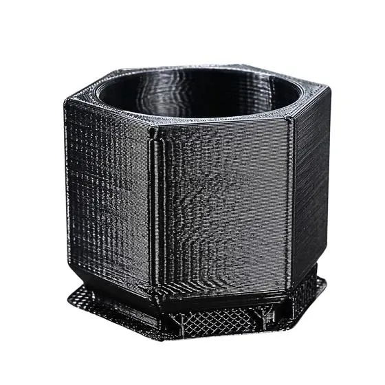 Unfinished black PLA 3D printed hex pot with visible layer lines